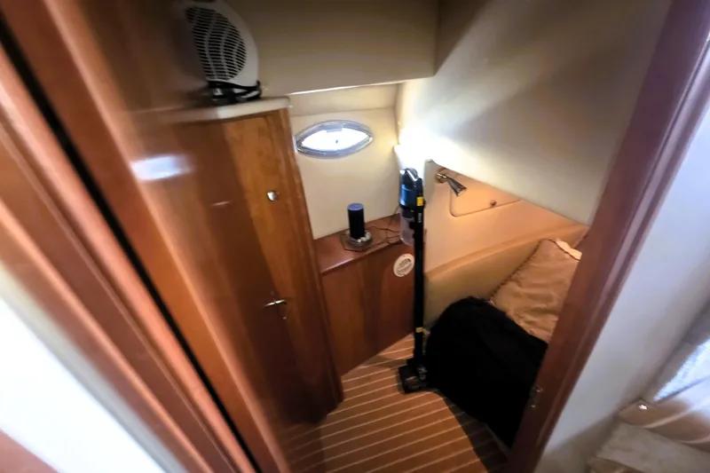 Slide: The Image of 2004 Meridian 391 Sedan cabin interior with wooden cabinetry and cozy sleeping area. - 14