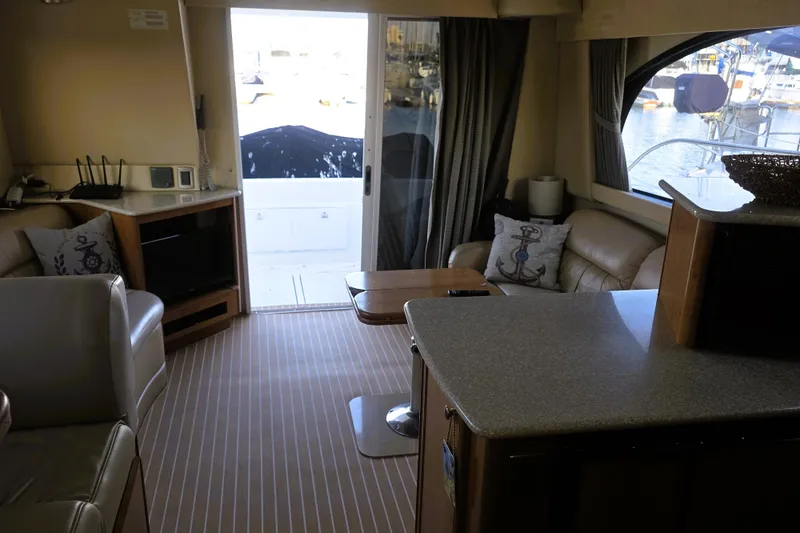 Slide: The Image of Interior of 2004 Meridian 391 Sedan yacht with cozy seating and nautical decor. - 17