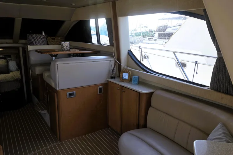 Slide: The Image of 2004 Meridian 391 Sedan interior with seating, table, and large window view. - 2