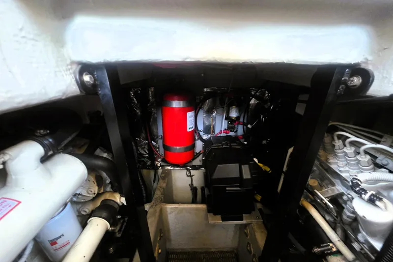 Slide: The Image of Engine room of 2004 Meridian 391 Sedan with visible fire extinguisher and mechanical components. - 25