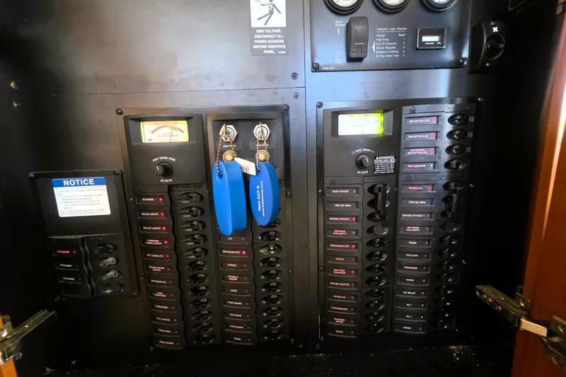 Slide: The Image of Electrical panel of a 2004 Meridian 391 Sedan boat with labeled switches and gauges. - 26