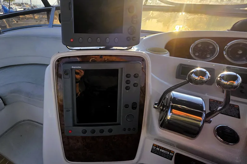 Slide: The Image of 2004 Meridian 391 Sedan helm with navigation controls and dual throttle levers. - 28