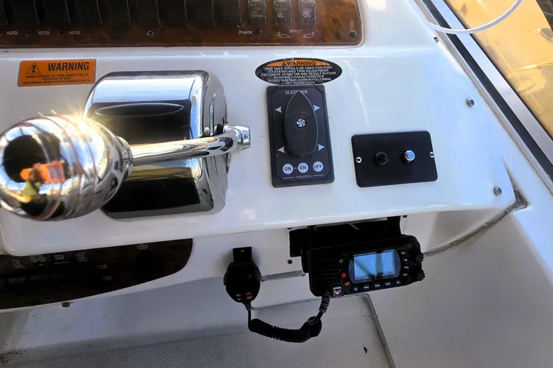 Slide: The Image of Control panel of a 2004 Meridian 391 Sedan boat with throttle and communication device. - 30