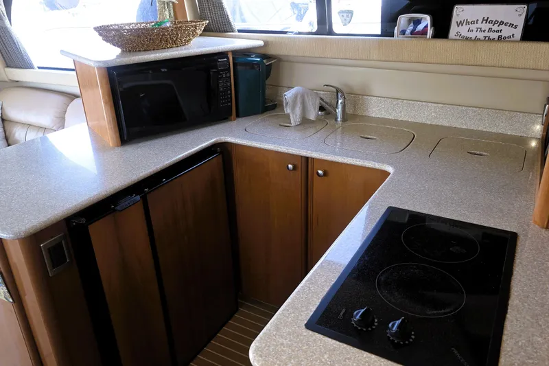 Slide: The Image of 2004 Meridian 391 Sedan yacht kitchen with microwave, stove, and sink. - 5