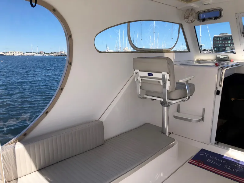 Slide: The Image of Interior of 2003 Mainship 30 Pilot II boat with seating and water view. - 12