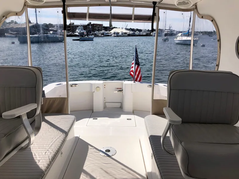 Slide: The Image of 2003 Mainship 30 Pilot II boat interior with harbor view and American flag. - 14