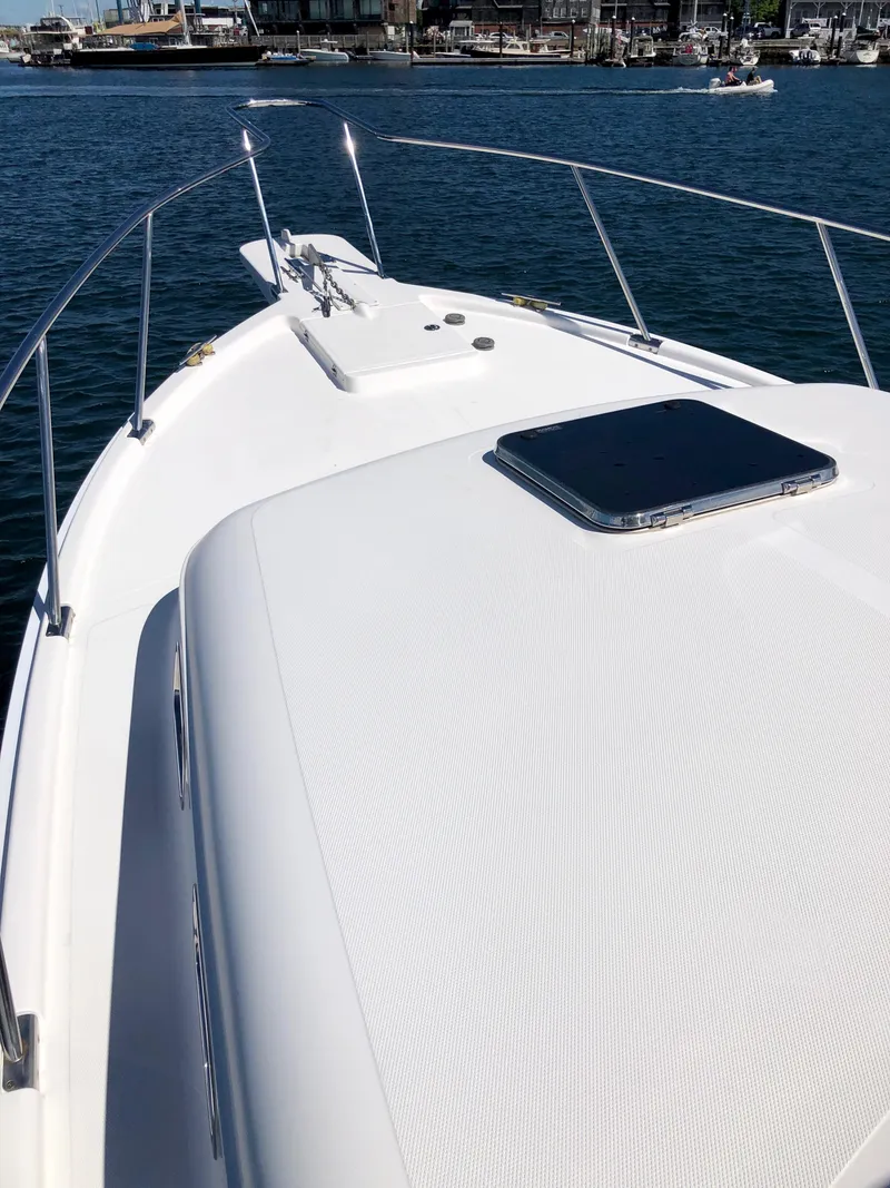 Slide: The Image of 2003 Mainship 30 Pilot II Hardtop boat deck on calm water. - 18
