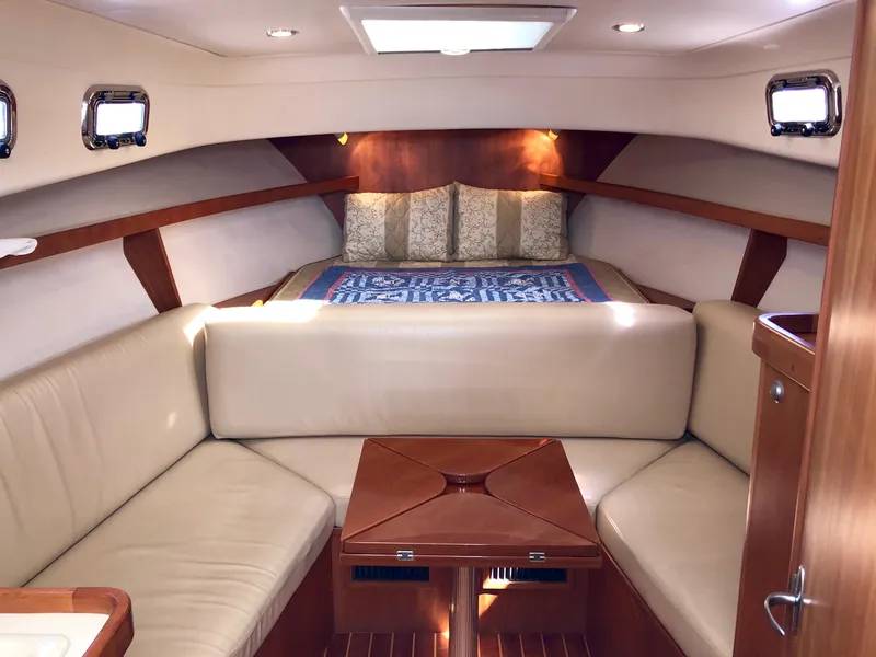 Slide: The Image of 2003 Mainship 30 Pilot II cabin interior with seating and bed. - 24