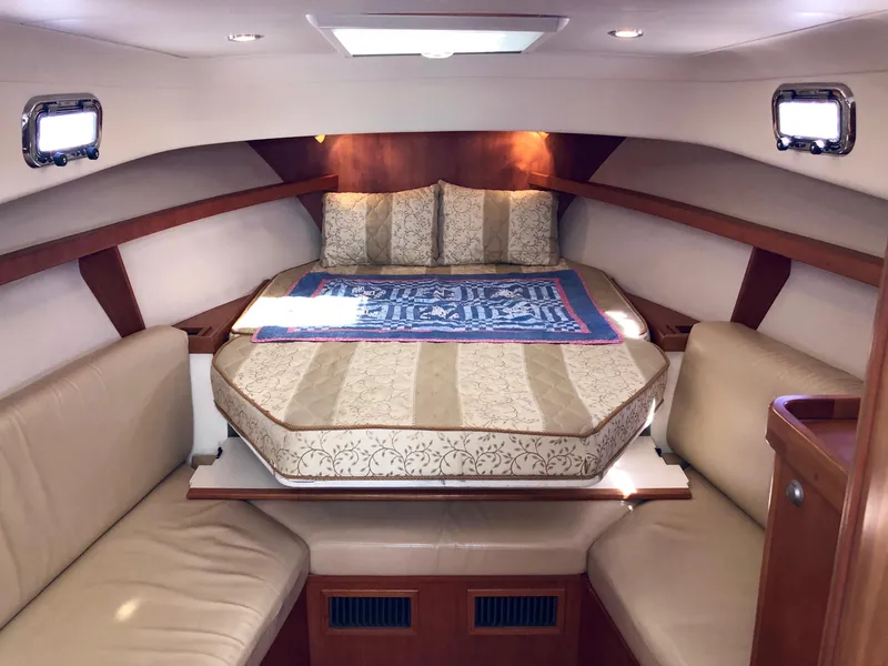 Slide: The Image of 2003 Mainship 30 Pilot II cabin interior with cozy bed and seating area. - 25