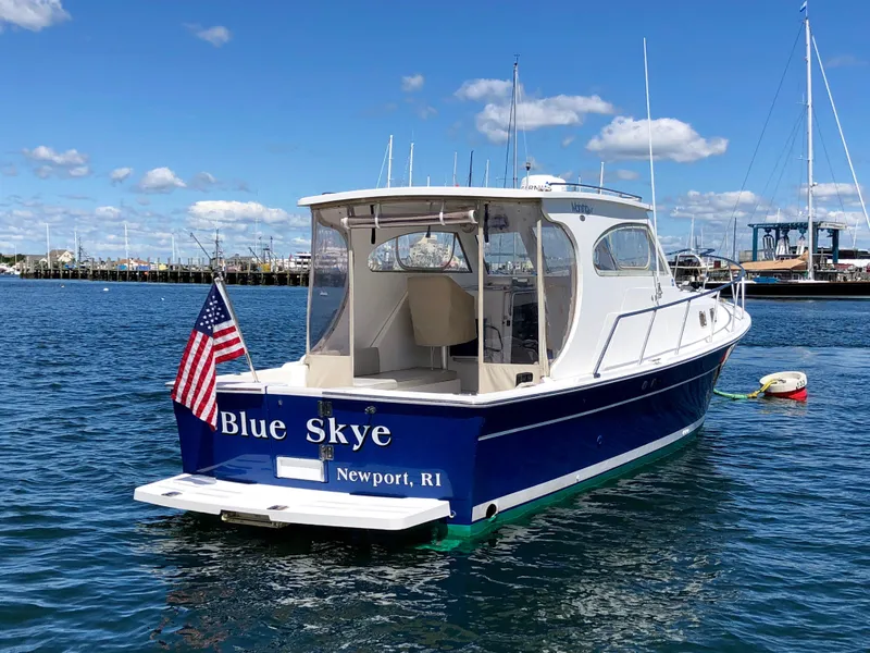 Slide: The Image of 2003 Mainship 30 Pilot II boat, "Blue Skye," docked in Newport, RI, with American flag. - 8