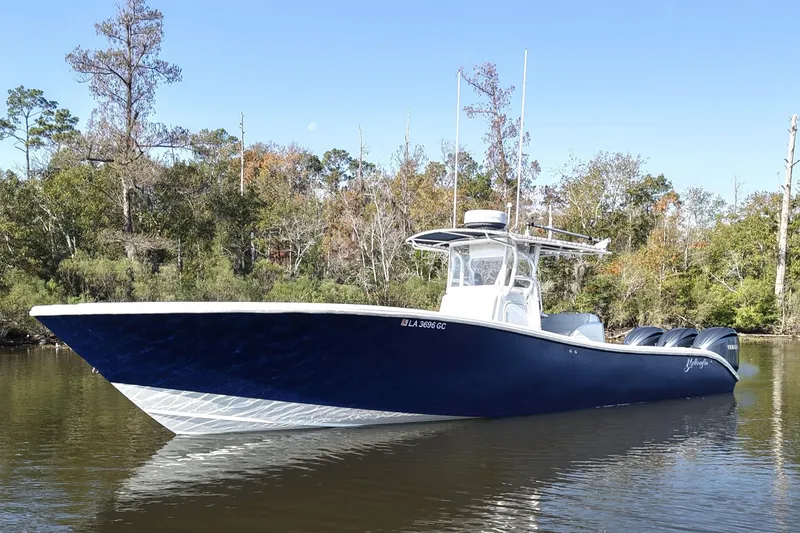 The Image of 2006 Yellowfin 36 Offshore boat on calm water, surrounded by trees. - 0
