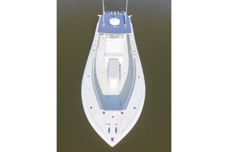 Slide: The Image of 2006 Yellowfin 36 Offshore boat, aerial view, sleek design, white and blue color scheme. - 10