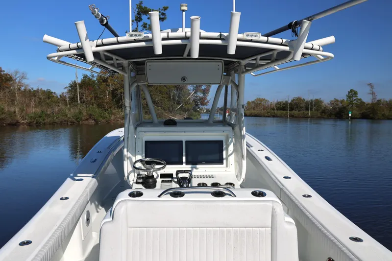 Slide: The Image of 2006 Yellowfin 36 Offshore boat on calm water, featuring a spacious cockpit and modern controls. - 12