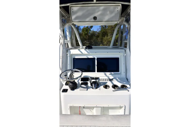 Slide: The Image of 2006 Yellowfin 36 Offshore boat helm with steering wheel and navigation screens. - 14