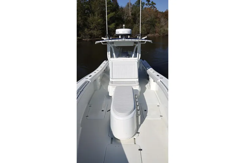 Slide: The Image of 2006 Yellowfin 36 Offshore boat, white deck, center console, calm water, forested background. - 15