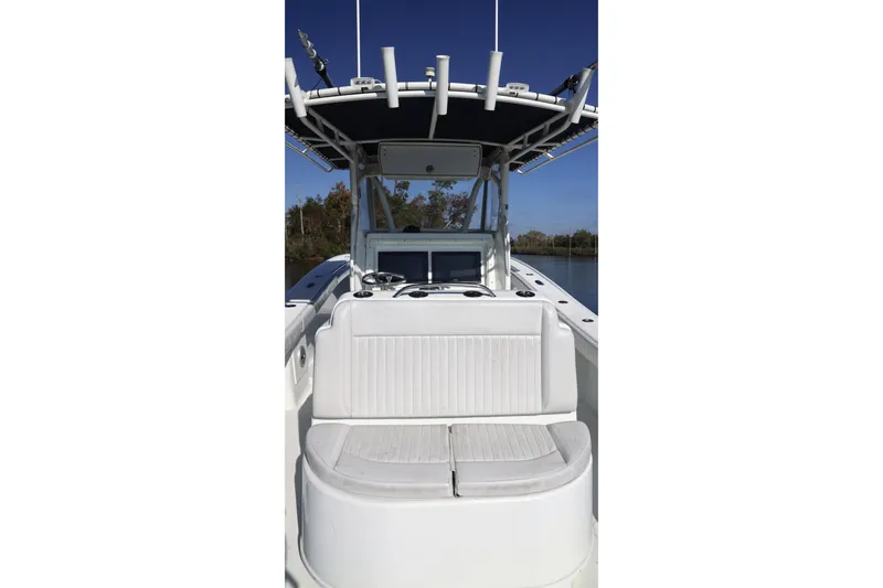 Slide: The Image of 2006 Yellowfin 36 Offshore boat interior with seating and console, under clear blue sky. - 18