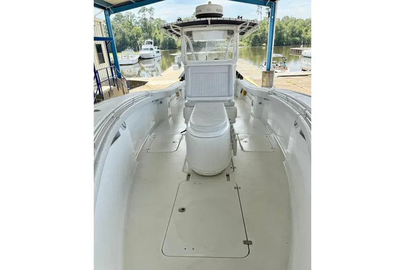 Slide: The Image of 2006 Yellowfin 36 Offshore boat on calm river, surrounded by lush trees. - 4