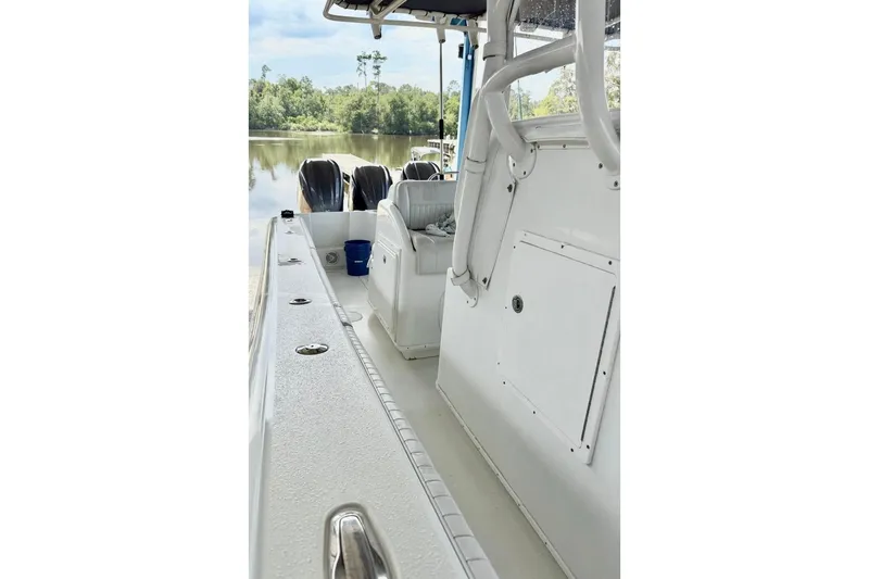 Slide: The Image of 2006 Yellowfin 36 Offshore boat with triple Yamaha engines on a calm river. - 6