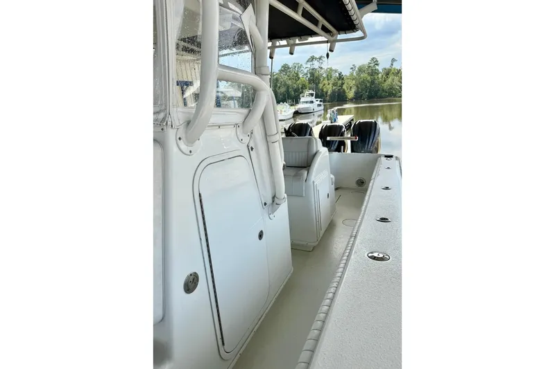 Slide: The Image of 2006 Yellowfin 36 Offshore boat with triple Yamaha engines on calm water. - 7