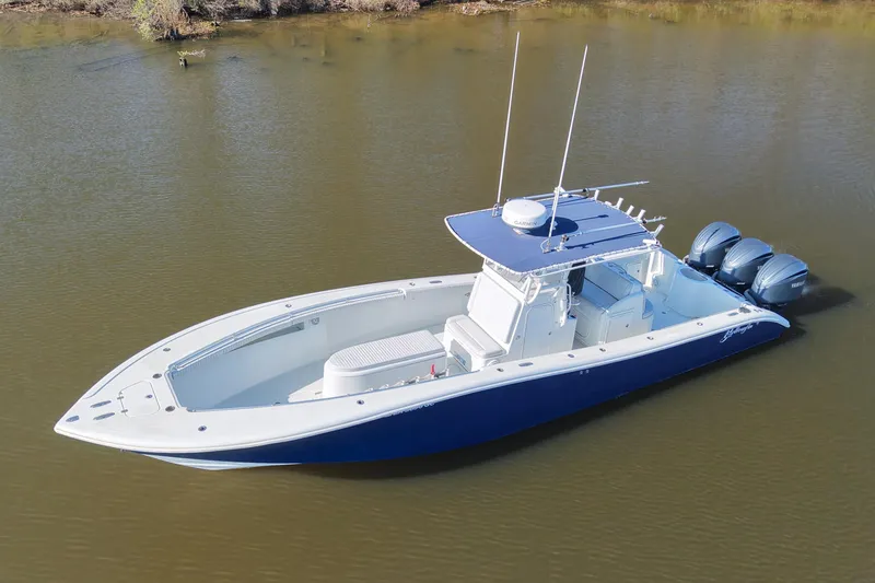 Slide: The Image of 2006 Yellowfin 36 Offshore boat with triple engines on calm water. - 9