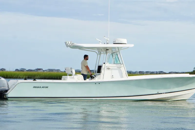 Slide: The Image of 2006 Regulator 32 Forward Seating boat on calm water, side view. - 4