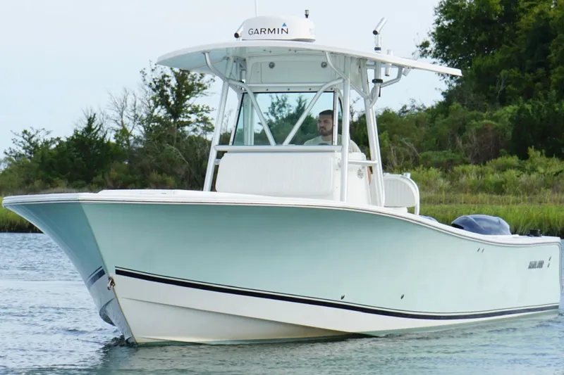 Slide: The Image of 2006 Regulator 32 Forward Seating boat cruising on a calm waterway. - 6