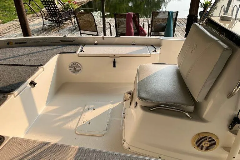 Slide: The Image of 2007 Century 2102 boat interior with seating and storage, dockside view. - 11