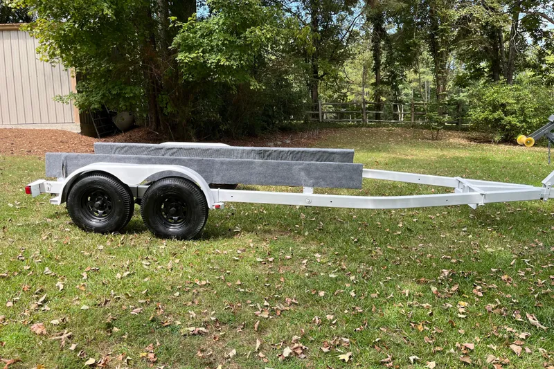 Slide: The Image of 2007 Century 2102 boat trailer on grassy yard with trees in background. - 13