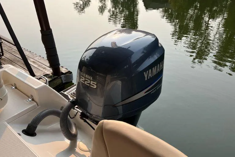 Slide: The Image of Century 2102 boat with Yamaha 225 engine, docked on calm water, 2007 model. - 2