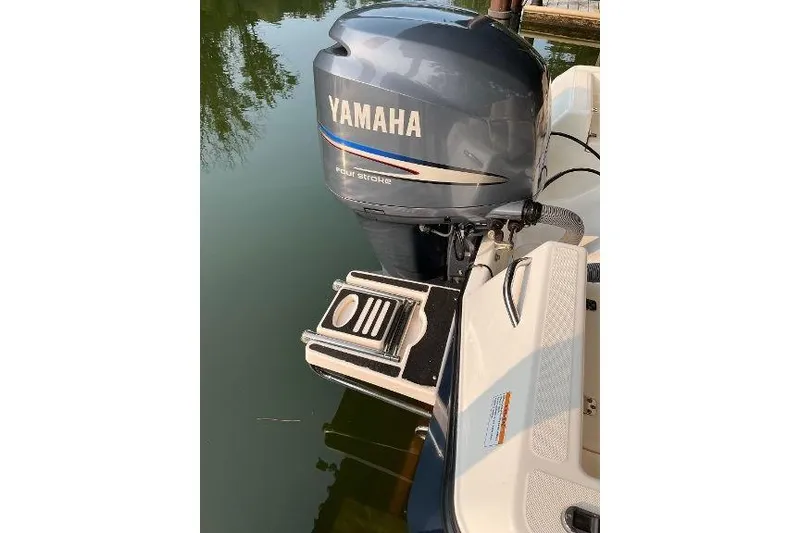 Slide: The Image of Century 2102 boat with Yamaha four-stroke engine, 2007 model, docked on calm water. - 3