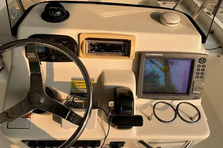 Slide: The Image of Dashboard of a 2007 Century 2102 boat with steering wheel and navigation system. - 6