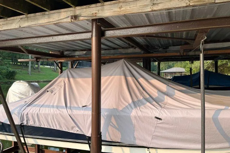 Slide: The Image of Covered 2007 Century 2102 boat docked under a metal roof. - 8