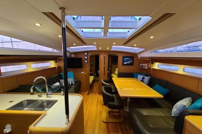 Slide: The Image of 2013 Jeanneau 57 yacht helm with wooden deck and steering wheel. - 19