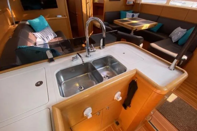 Slide: The Image of Mast and radar equipment on a 2013 Jeanneau 57 sailboat against a clear blue sky. - 24