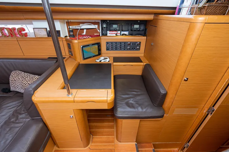 Slide: The Image of Luxurious 2013 Jeanneau 57 yacht interior with spacious seating and elegant design in a marina. - 25