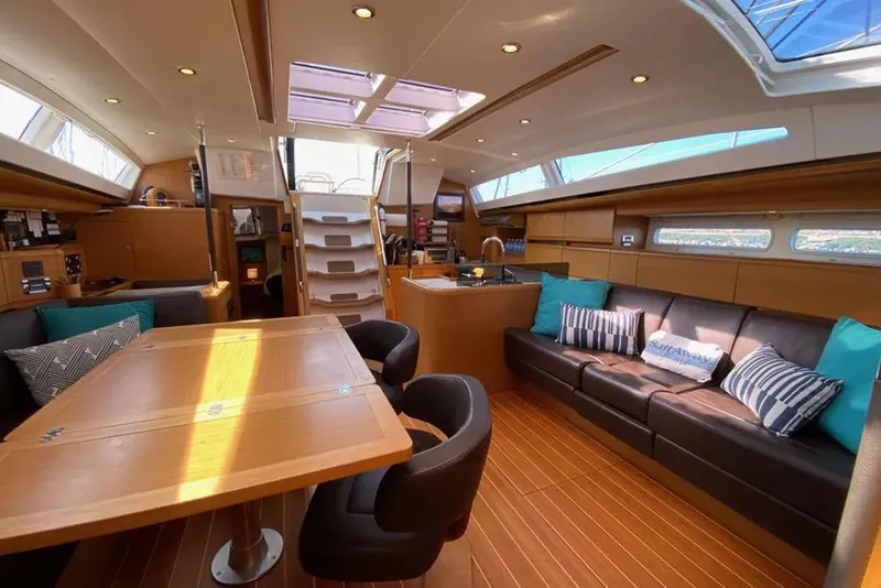 Slide: The Image of Luxurious interior of a 2013 Jeanneau 57 yacht featuring a modern kitchen and seating area. - 27