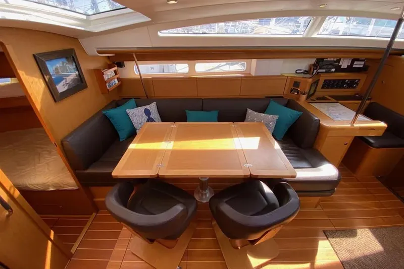 Slide: The Image of Luxurious interior of a 2013 Jeanneau 57 yacht with elegant wood finishes and seating. - 28