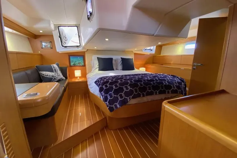 Slide: The Image of Microwave in 2013 Jeanneau 57 yacht kitchen, featuring sleek wooden cabinetry. - 32