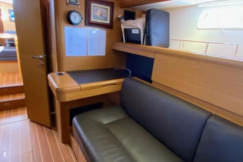 Slide: The Image of Interior of 2013 Jeanneau 57 yacht with cozy seating and elegant wood finish. - 38