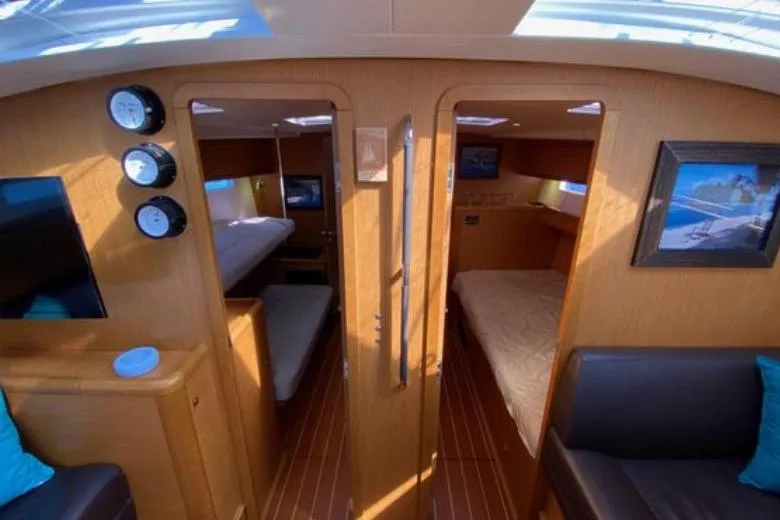 Slide: The Image of Cozy cabin interior of 2013 Jeanneau 57 yacht with wooden finishes and comfortable bedding. - 39
