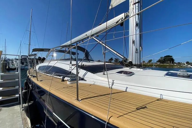 Slide: The Image of 2013 Jeanneau 57 yacht docked at marina with clear blue sky. - 4