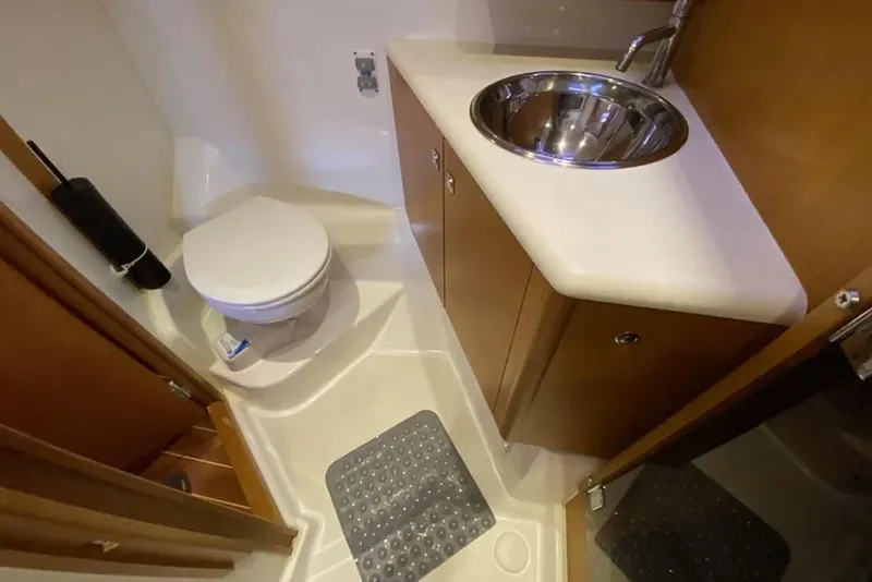 Slide: The Image of Interior of 2013 Jeanneau 57 yacht with wooden bunk beds and storage cabinets. - 44