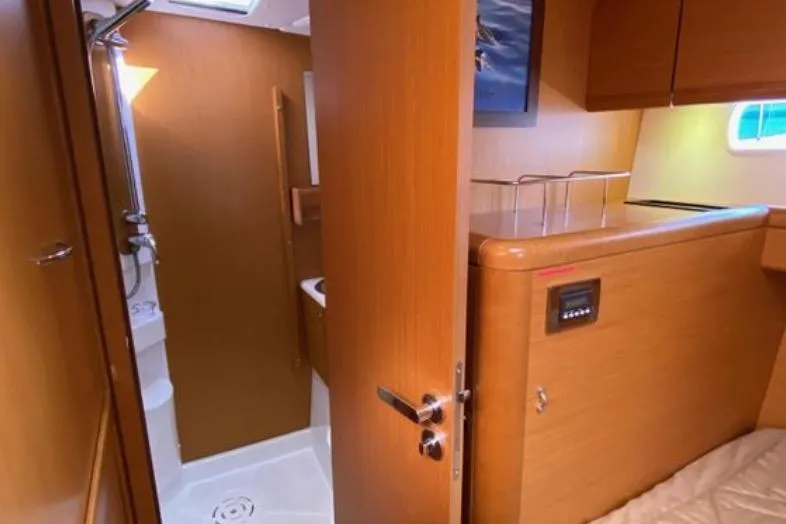 Slide: The Image of Cozy cabin interior of 2013 Jeanneau 57 yacht with skylight and wooden finish. - 48