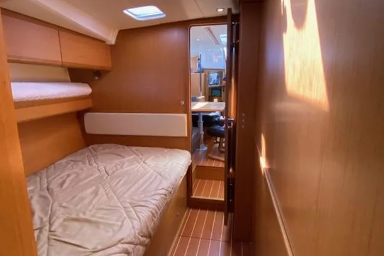 Slide: The Image of 2013 Jeanneau 57 yacht interior with wooden flooring and bunk beds. - 50