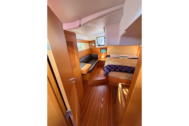 Slide: The Image of Luxurious interior of 2013 Jeanneau 57 yacht with cozy bedroom and seating area. - 56