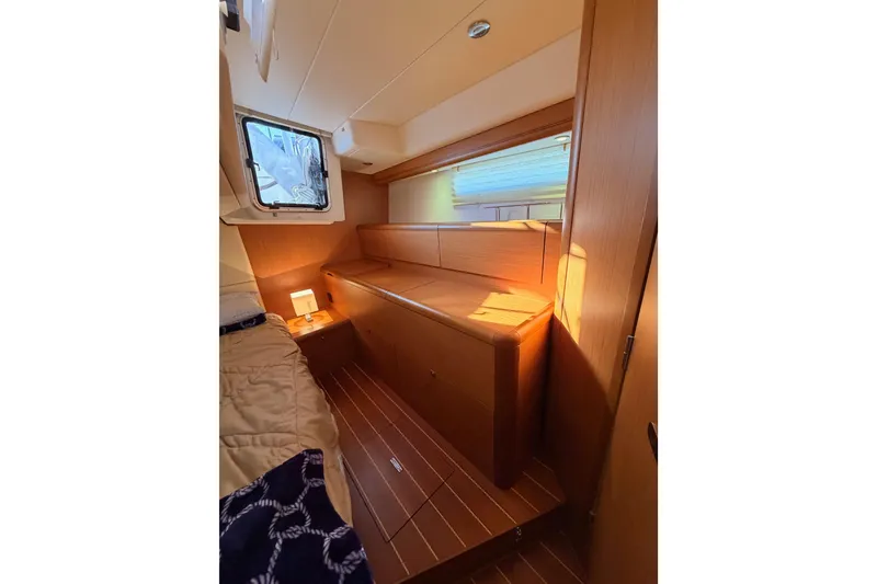 Slide: The Image of Interior of 2013 Jeanneau 57 yacht cabin with wooden furnishings and cozy lighting. - 59