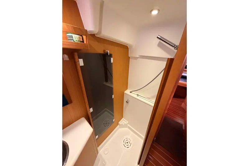 Slide: The Image of Bathroom interior of 2013 Jeanneau 57 yacht with shower and wooden accents. - 61
