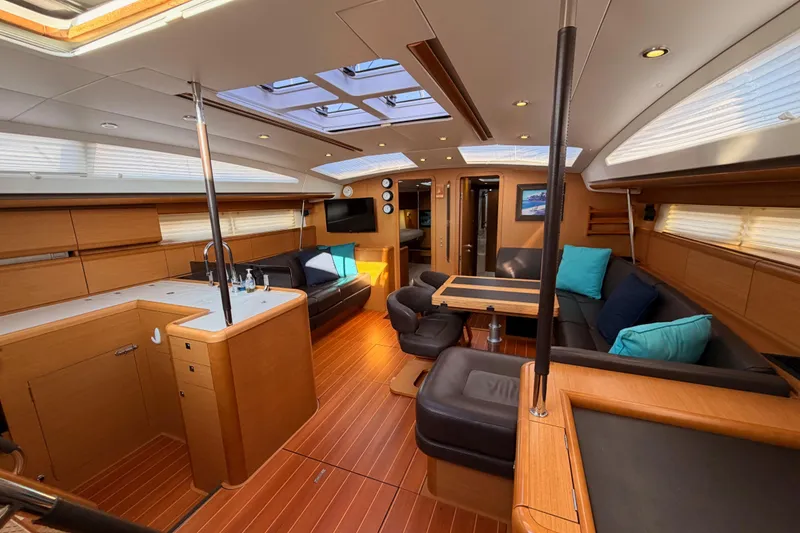Slide: The Image of Luxurious interior of a 2013 Jeanneau 57 yacht with modern furnishings and ample natural light. - 65