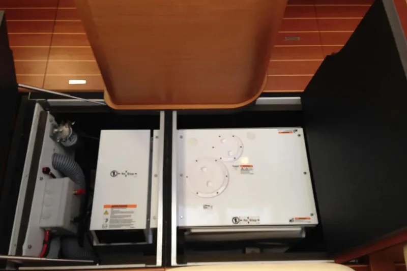 Slide: The Image of Engine compartment of a 2013 Jeanneau 57 yacht, showcasing mechanical components. - 68