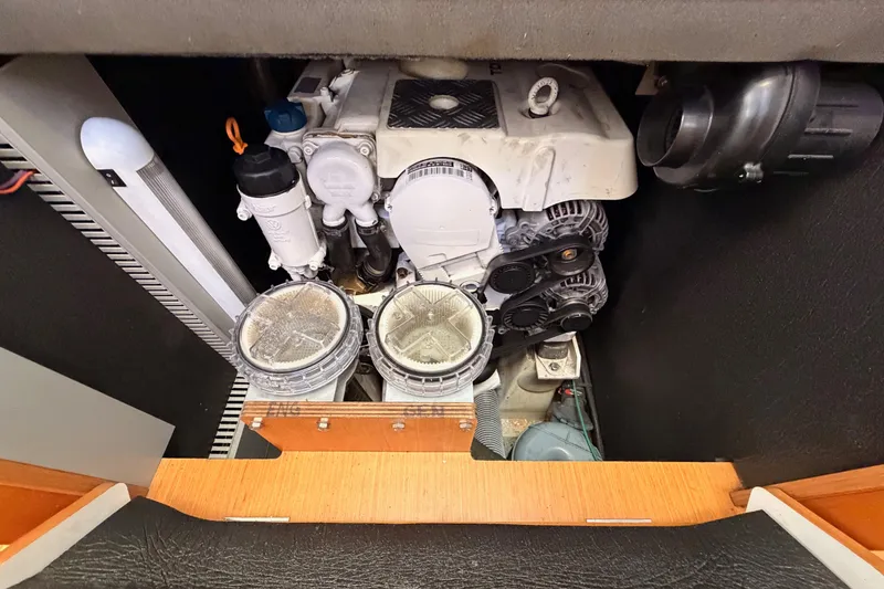 Slide: The Image of Engine compartment of a 2013 Jeanneau 57 sailboat, showcasing mechanical components. - 70